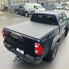 Black matte soft tonneau cover fitted on the back side of a black toyota hilux 2015-2020 sr5 double cab bed