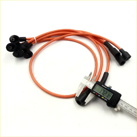 Orange spark plug ignition wires with black connectors measured by digital caliper for datsun nissan cabstar
