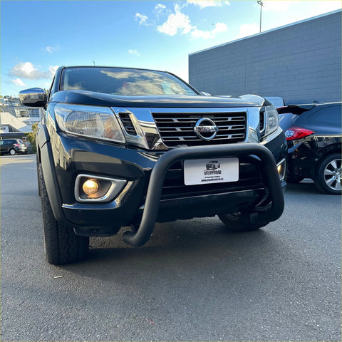 Black nissan navara pickup truck with matte black stainless steel nudge bar and chrome grille front bumper guard
