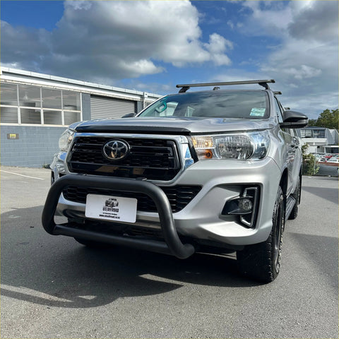 Silver toyota hilux with black stainless steel medium size matte nudge bar front bull bar and roof rack