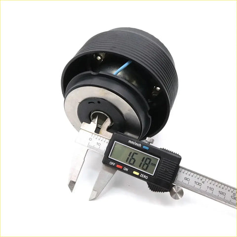 Black ribbed steering wheel hub adapter with silver metallic center and visible wiring for Nissan Sunny Sentra 1981-2000
