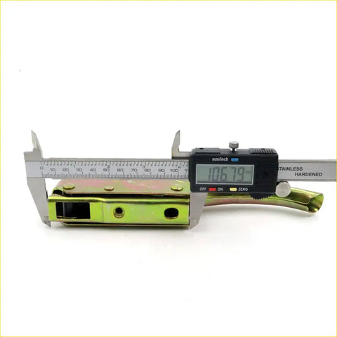 A lime green and silver metallic tailgate handle with a digital caliper measuring width for nissan datsun 620 ute