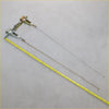 Metallic lever-operated tail gate lock latch with two slender rods and yellow tape for scale for toyota hilux 86-97