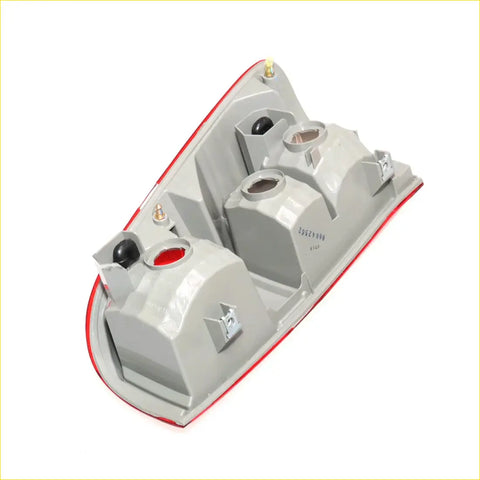 Backside of gray plastic tail light housing with red trim and circular bulb openings for toyota hilux sr5 2011-2015
