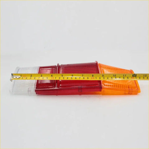 Tail light lens set for mazda b1800 with red and orange translucent plastic and a clear lens on one end