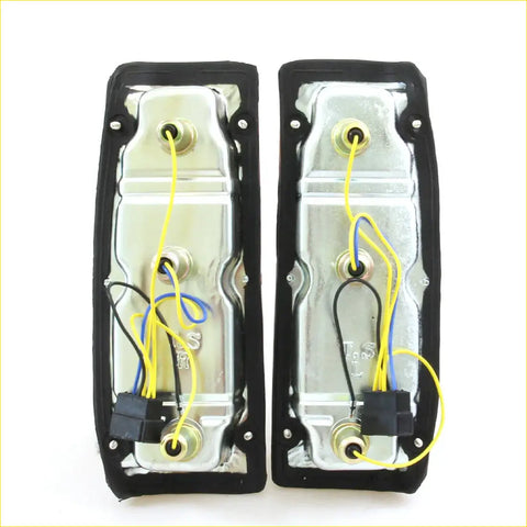 Pair of chrome finished rectangular tail light assemblies with black rubber trim and wiring for nissan datsun 720 80s