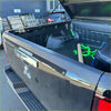Backside of black mitsubishi triton 2024 tailgate cover with chrome handle and textured black bed liner