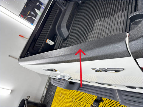 Black textured bed liner tailgate cover with matte finish installed on rear of white ford ranger px1 2 3 2012-2021