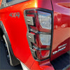 Back view of red isuzu d-max 4x4 truck tail light with chrome trim and layered led design matte black taillight cover
