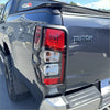 Rear taillight covers for mitsubishi triton 2019-2023 in matte black with red clear lenses and black plastic housing