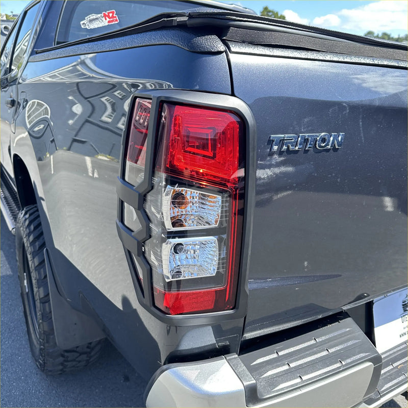 Rear taillight covers for mitsubishi triton 2019-2023 in matte black with red clear lenses and black plastic housing