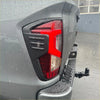 Taillight covers for nissan navara 2021 plus with bold red led lens and matte black plastic bezel matching dark gray truck