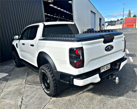 White ford ranger pickup truck with black accents and rugged off-road tires featuring tomahawk hardlid next gen 2022-current