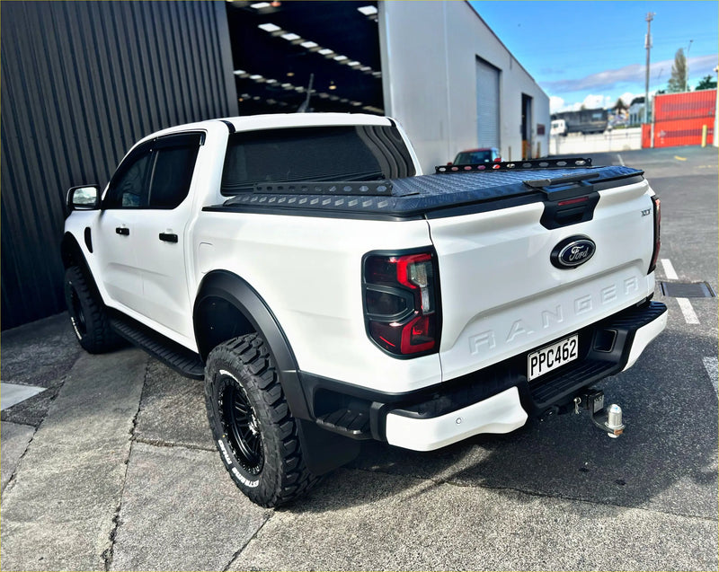 White ford ranger pickup truck with black accents and rugged off-road tires featuring tomahawk hardlid next gen 2022-current