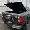 Black toyota hilux srs double cab with a lifted tomahawk aluminium hardlid bed cover shown from the back side