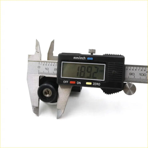 A black digital caliper with a silver metallic body showing mm and inch measurements used for toyota hilux vacuum switch