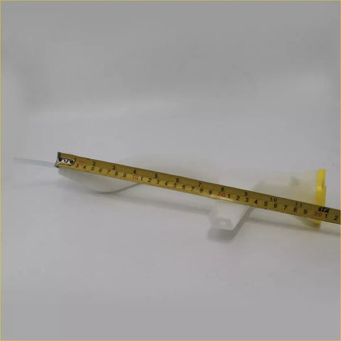 Yellow metal tape measure with black markings and yellow casing next to washer bottle tank for nissan np300 d22 terrano