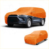 Bright orange waterproof all weather car cover with reinforced seams snugly fits over dark blue toyota highlander suv