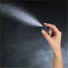 Black plastic windshield washer nozzle spraying fine mist held in hand for toyota 4wd ute offroad use